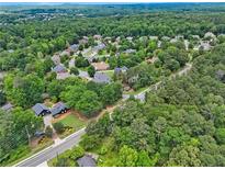 An aerial view of a lush neighborhood with mature trees and well-maintained homes at 905 John Ward Rd, Marietta, GA 30064