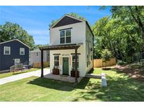 Charming two-story home with a modern design and a well-manicured lawn at 1473 Lansing Se St, Atlanta, GA 30315
