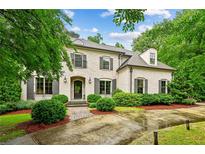 Elegant two-story brick home featuring manicured landscaping and classic architectural details at 2115 Howell Mill Nw Rd, Atlanta, GA 30318