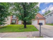 Charming brick home with well-manicured lawn and two-car garage at 7190 Cavender Sw Dr, Atlanta, GA 30331