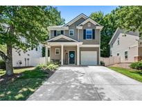 Charming two-story home with a well-maintained yard, covered front porch, and single-car garage at 130 Nacoochee Way, Canton, GA 30114
