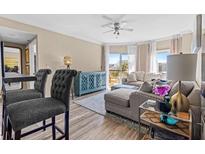 Bright and airy living room featuring a comfortable sofa, balcony access, and stylish decor at 1 Biscayne Nw Dr # 804, Atlanta, GA 30309
