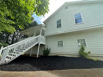 Two-story home with white siding, a front porch and mulch landscaping at 186 Grapevine Dr, Douglasville, GA 30134