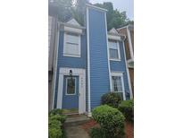 Charming two-story home with blue siding and a well-maintained front yard at 6620 Wellington Sq, Norcross, GA 30093