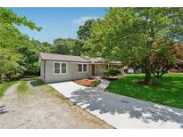 Charming one-story home with a well-manicured lawn and newly paved driveway at 2060 Panstone Sw Ct, Marietta, GA 30060