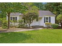 Charming one-story home featuring a well-maintained lawn and a quaint walkway leading to the front door at 1891 8Th St, Atlanta, GA 30341