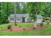 Charming single-story home with manicured front lawn, mature trees, and welcoming curb appeal at 3286 Crawford Cir, Marietta, GA 30066