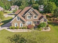 Inviting two-story brick home with manicured lawn and mature landscaping at 2900 Sutton Pl, Conyers, GA 30013