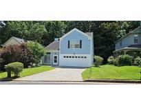 Charming two-story home with a well-maintained lawn and attached two-car garage at 4965 N Bridges Dr, Alpharetta, GA 30022