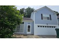 Charming two-story home with blue siding, white trim, and an attached garage at 4965 N Bridges Dr, Alpharetta, GA 30022