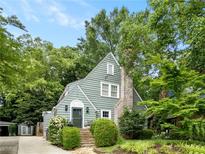 Charming exterior view of home with a stone walkway leading to the front door, framed by lush greenery at 2054 Palifox Ne Dr, Atlanta, GA 30307
