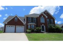 Charming brick home with a two-car garage and manicured lawn at 804 Bridle Cove, Stockbridge, GA 30281