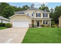 Charming two-story home with a well-manicured lawn, attached garage, and inviting front porch at 2840 Brookford Sw Ln, Atlanta, GA 30331