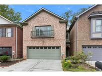 Charming brick home with a two-car garage and Juliet balcony offers curb appeal at 1666 Oakbrook Lake Dr, Norcross, GA 30093