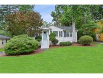 Charming home with a well-manicured lawn, inviting entryway, and lush landscaping at 1680 Bristol Ne Dr, Atlanta, GA 30329