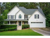Charming two-story home with a well-manicured lawn and attached two car garage at 111 Bexley Ln, Douglasville, GA 30134