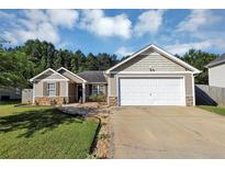 Charming one-story home featuring stone accents, neutral siding, and a well-manicured lawn with an attached two-car garage at 109 Rockefeller Ln, Dallas, GA 30157