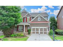 Charming two-story home with well-manicured lawn, colorful flowerbeds, and a two-car garage at 4495 Hedgewood Dr, Cumming, GA 30041