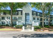 Attractive condo building exterior with mature trees, well-maintained landscaping, and covered entrance at 1105 Pine Heights Ne Dr, Atlanta, GA 30324