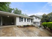 Charming split-level home featuring a well-manicured front yard and a convenient carport at 3664 Pin Oak Cir, Atlanta, GA 30340