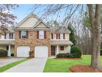 Charming townhome with brick and siding, complemented by a well-manicured lawn at 184 Darbys Crossing Ct, Hiram, GA 30141