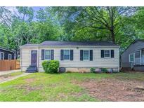 Charming home featuring symmetrical window shutters and a well-kept front lawn at 2239 Carey Se Dr, Atlanta, GA 30315