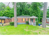 Charming single-story brick home with a front porch and landscaped yard at 2817 Burton Nw Rd, Atlanta, GA 30311