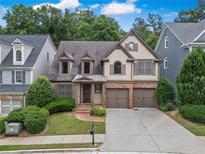Charming home featuring two-car garage, manicured lawn and inviting front entrance at 3725 Paces Park Se Cir, Smyrna, GA 30080