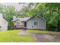 Charming single-story home featuring stone accents, a cozy front porch, and a well-maintained lawn at 2654 Laurel View Dr, Snellville, GA 30039