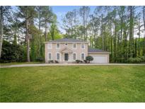 Charming two-story home with a well-manicured lawn and attached two-car garage at 2799 Lake Jodeco Rd, Jonesboro, GA 30236