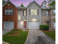 Charming two-story home with a well-manicured lawn, attached garage, and inviting front entrance at 780 Nehemiah Sw Ln, Atlanta, GA 30331