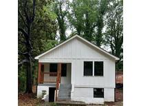 Charming home featuring a board and batten facade and a cute porch with wood columns and railings at 2004 Detroit Nw Ave, Atlanta, GA 30314