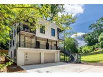 Modern, multi-level home featuring balconies, a two-car garage, and unique architectural details at 240 Patterson Se Ave, Atlanta, GA 30316