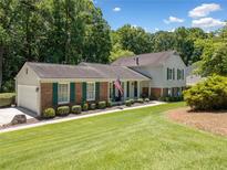 Charming two-story home with manicured lawn, brick accents, and green shutters at 237 Lamplighter Ln, Marietta, GA 30067