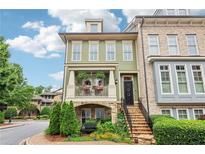 Charming two-story home featuring a quaint porch with a garden and a brick-lined walkway up to the front door at 4588 Pine Se St, Smyrna, GA 30080