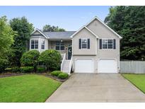 Charming two-story home with a well-maintained lawn and two-car garage at 74 Knights Ct, Dallas, GA 30157