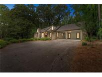 Charming stone home featuring a covered carport and a spacious driveway at 2596 Midway Rd, Decatur, GA 30030