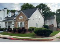 Beautiful exterior view showcasing stone accents, well-maintained landscaping, and a cozy suburban setting at 636 Lantern Park Ln, Scottdale, GA 30079