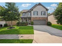 Charming two-story home with manicured lawn and stone accents, creating inviting curb appeal at 2127 Apple Orchard Way, Austell, GA 30168