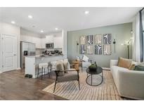Open-concept living room featuring modern decor, stylish furniture, and a breakfast bar connected to the kitchen at 2363 Haran Dr # 35, Lithonia, GA 30058