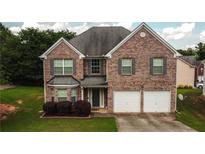 Charming brick two-story home with a two-car garage and well-maintained front lawn at 4676 Shaded Oak Ln, Forest Park, GA 30297