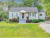 Charming one-story home featuring a well-manicured lawn and inviting front porch at 118 Greenwood St, Fairburn, GA 30213