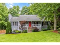 Charming gray two-story home with a manicured front yard and inviting red front door at 5761 E Emerald Oaks Ln, Acworth, GA 30102