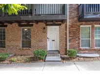 Charming brick townhome featuring a clean white front door and well-maintained landscaping for inviting curb appeal at 7307 Cardigan Cir, Sandy Springs, GA 30328