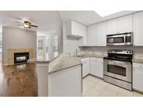 Bright kitchen features granite countertops, stainless steel appliances, and open access to the living room at 123 Mcgill Park Ave # 123, Atlanta, GA 30312