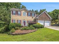Charming two-story home featuring a landscaped yard and a two-car garage, perfect for Gathering living at 474 Boxelder Rd, Atlanta, GA 30349