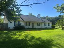 Charming single-story home boasts a well-manicured lawn and classic design at 75 Plantation Ln, Locust Grove, GA 30248