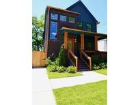 Charming two-story home featuring dark brick, wood trim, and a welcoming front porch at 1122 Rice Nw St, Atlanta, GA 30318