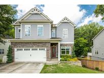 Beautiful two-story home featuring stone accents and a well-manicured lawn at 2573 Paul Nw Ave, Atlanta, GA 30318