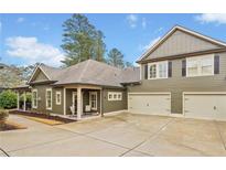 Charming home featuring a neutral color, well-maintained lawn, a two-car garage, and a cozy front porch at 84 Cedarcrest Village Ln, Acworth, GA 30101